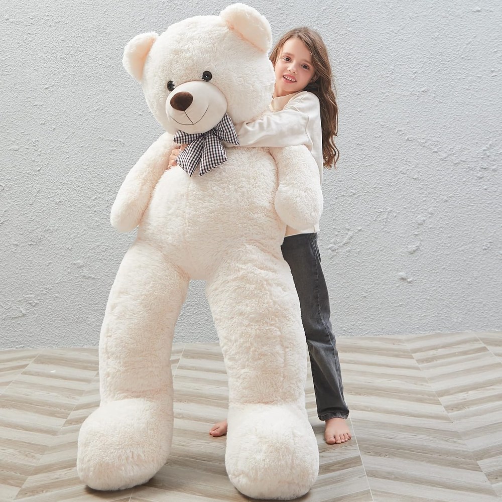 A person standing next to a two-metre teddy bear for scale