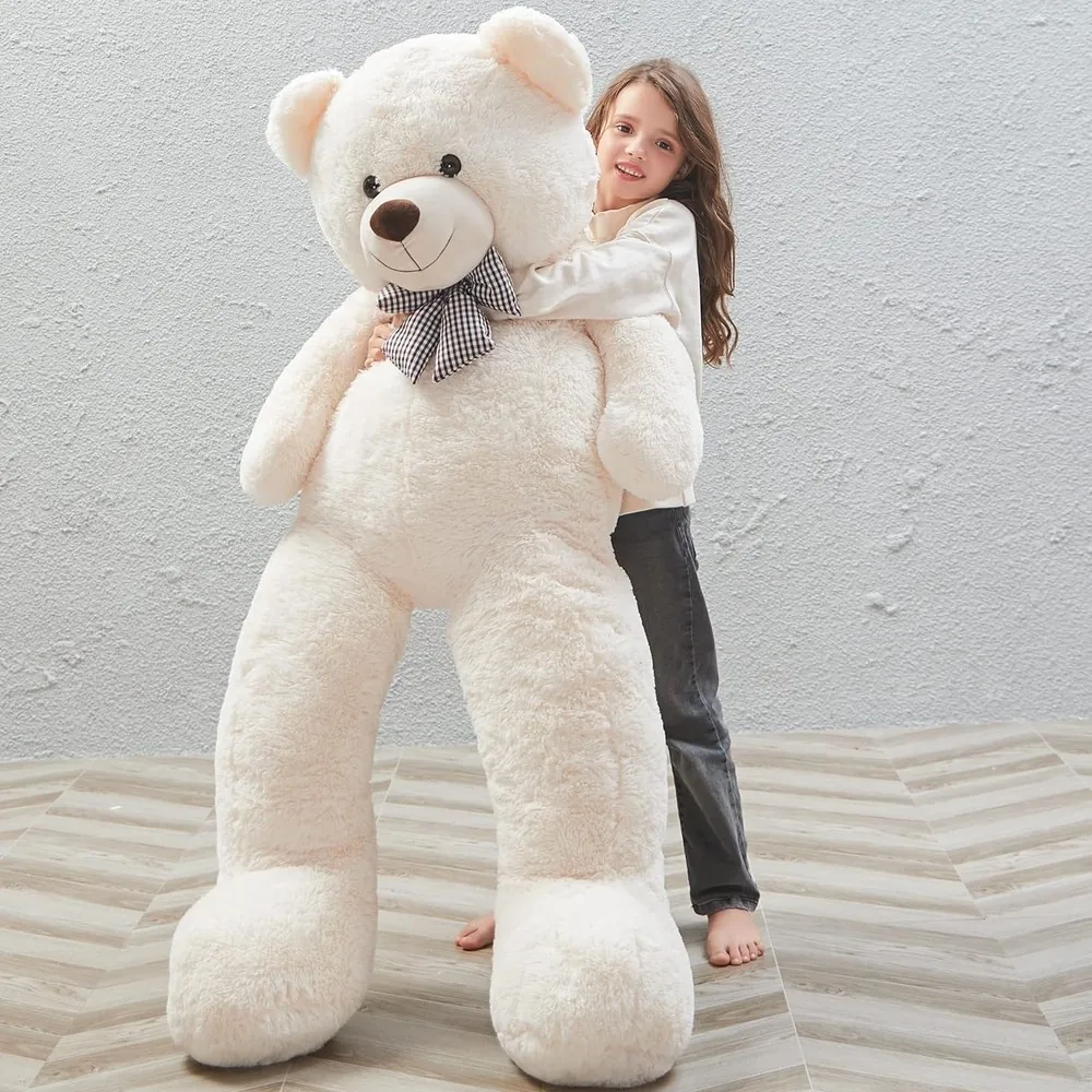 A person standing next to a two-metre teddy bear for scale